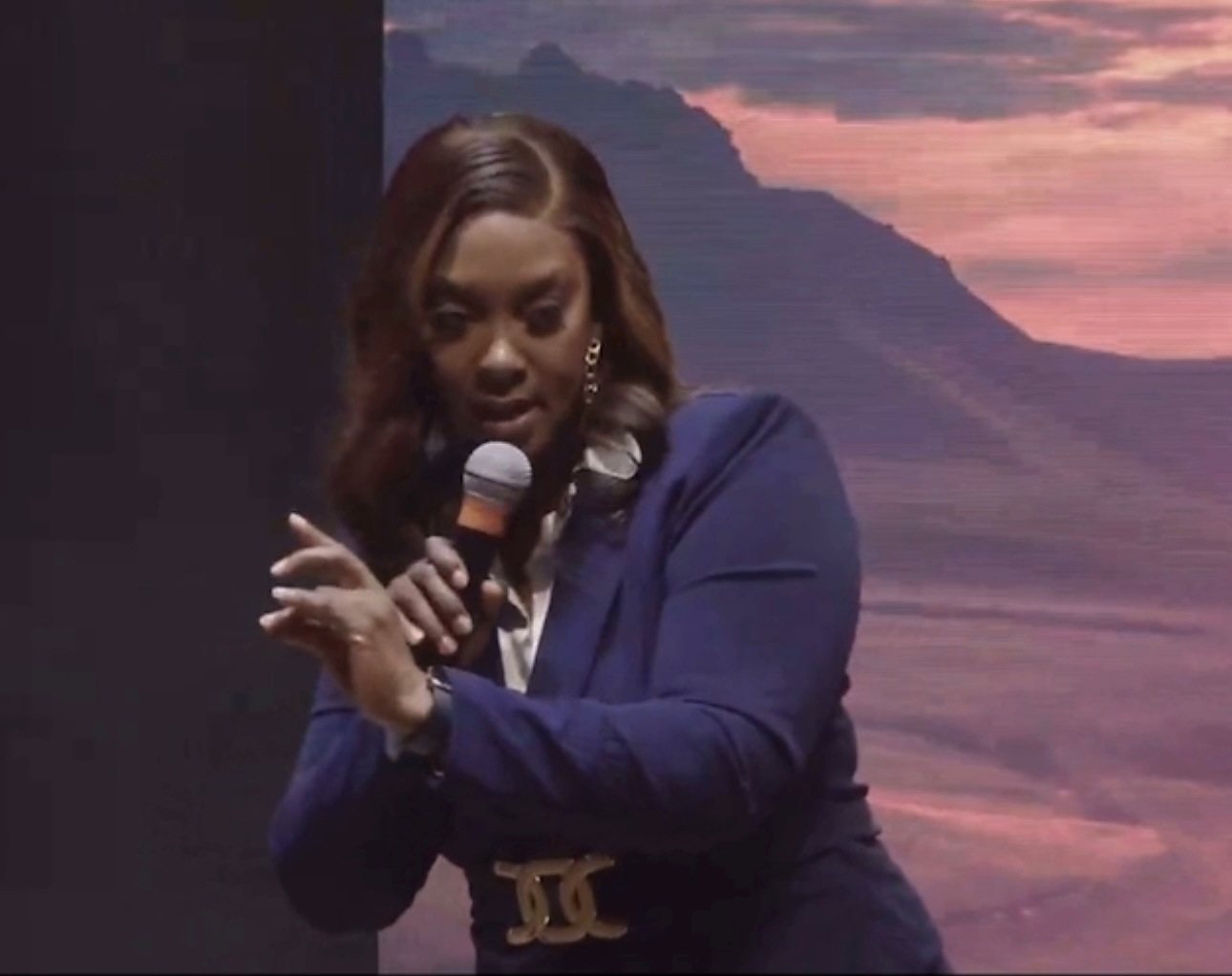 Rhonda E. Augustus speaking on stage with a microphone